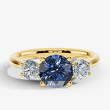 "Bluzz" Round Cut 1.5 Carat Blue Sapphire Trilogy Yellow Gold Engagement Ring Render- Front view