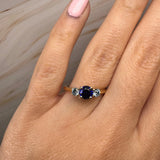 "Bluzz" Round Cut 1.5 Carat Blue Sapphire Trilogy Yellow Gold Engagement Ring Life style- Top view