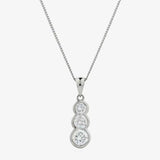 Round cut solitaire in three stone rub over setting HEERA